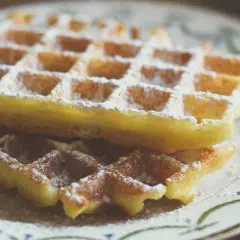 Dwa puszyste gofry posypane cukrem pudrem, jakby prosto z nad morza. Idealne na letnie popołudnie.