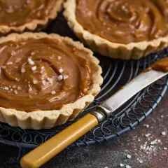 Słodkie tartaletki czekoladowe z karmelem i solą morską, gotowe do degustacji.